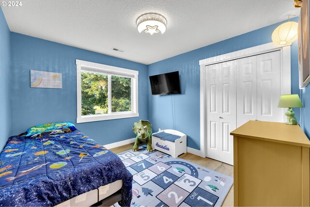 bedroom with a closet and light wood-type flooring