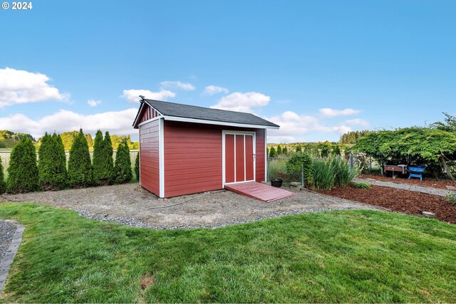 view of outbuilding with a yard