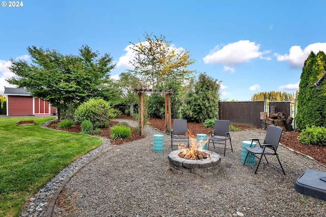 view of yard with an outdoor fire pit and a shed