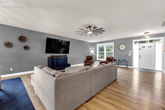 living room with ceiling fan and light wood-type flooring