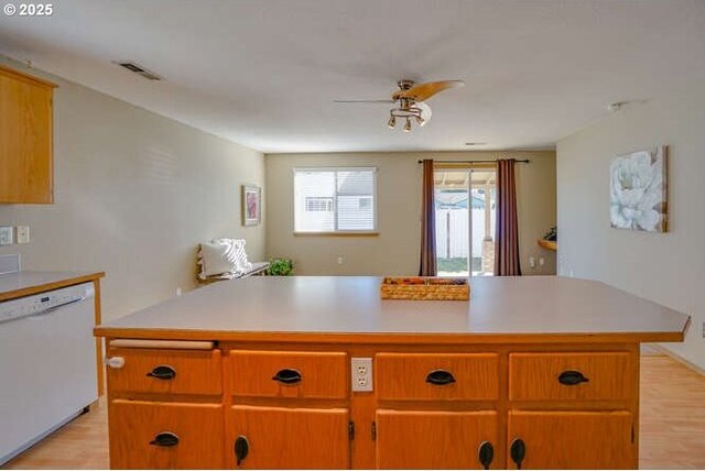 kitchen featuring light wood-style flooring, visible vents, white dishwasher, ceiling fan, and light countertops