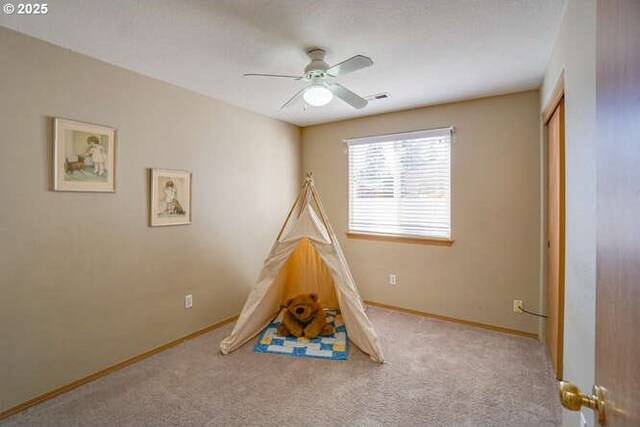 game room with baseboards, a ceiling fan, visible vents, and carpet