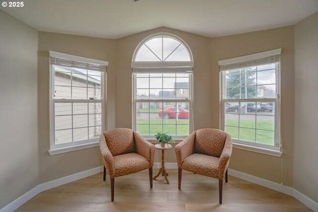 living area featuring baseboards and wood finished floors