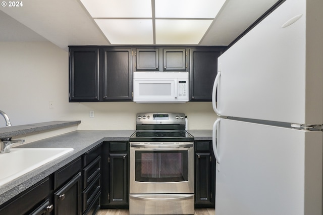 kitchen with white appliances and sink