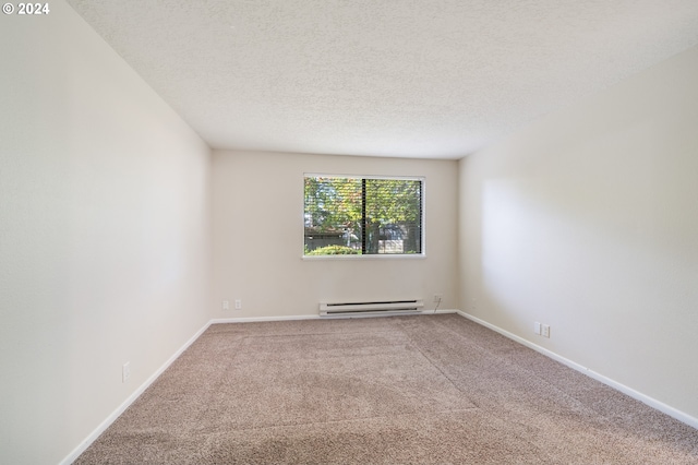 carpeted empty room with a textured ceiling and baseboard heating