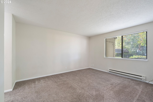 carpeted spare room featuring a textured ceiling and a baseboard heating unit