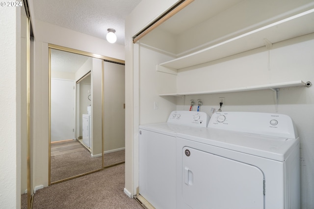 washroom with a textured ceiling, washing machine and clothes dryer, and carpet