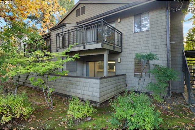 back of house with a balcony