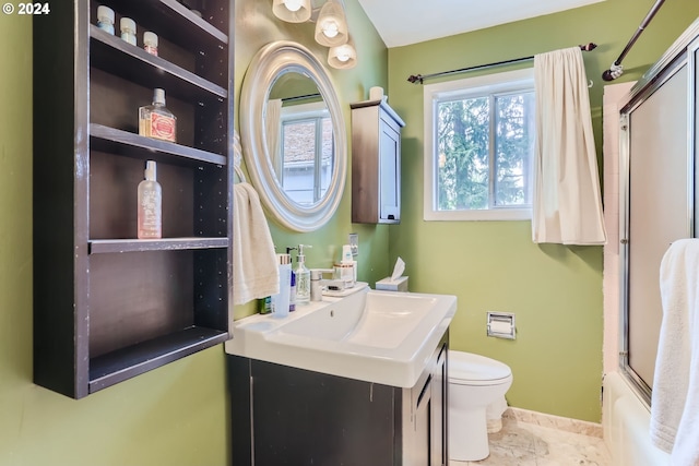 full bathroom with vanity, bath / shower combo with glass door, toilet, and tile patterned flooring