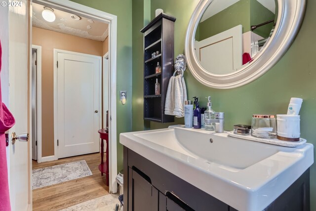 bathroom with vanity and hardwood / wood-style flooring