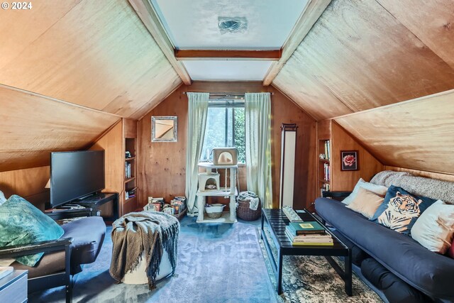 interior space featuring vaulted ceiling, wooden walls, and carpet