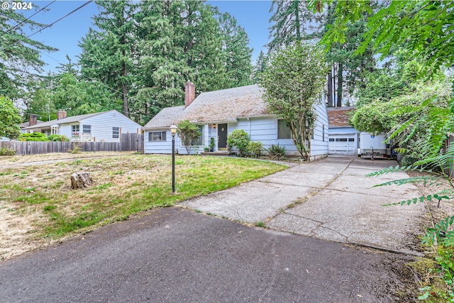 view of front of property with a front yard and a garage