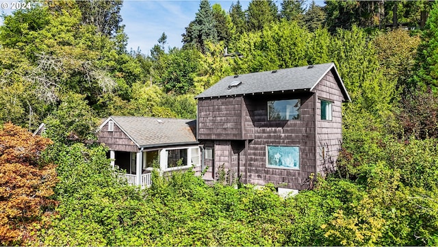637 NW Skyline Crest Rd, Portland, OR 97229 - view of front of property featuring roof with shingles and a wooded view
