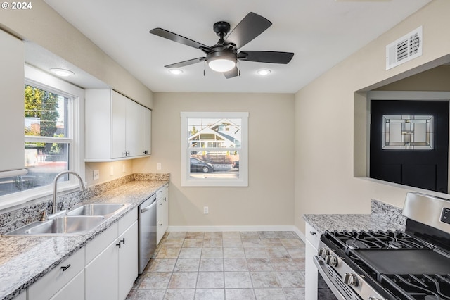 kitchen with stainless steel appliances, white cabinetry, ceiling fan, and sink