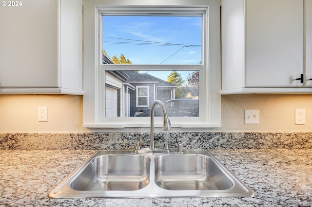 room details featuring white cabinetry and sink