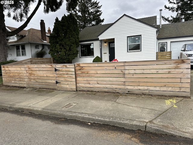 view of front of home featuring a fenced front yard and a gate