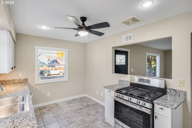 8510 SE Washington St, Portland, OR 97216 - kitchen with gas stove, ceiling fan, white cabinetry, and recessed lighting