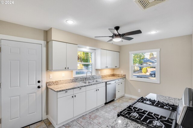 kitchen featuring a sink, visible vents, baseboards, dishwasher, and a ceiling fan