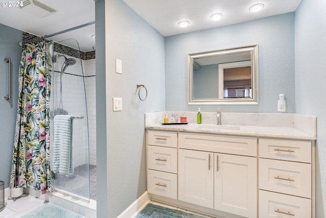 bathroom with tile patterned floors, a shower with curtain, and vanity