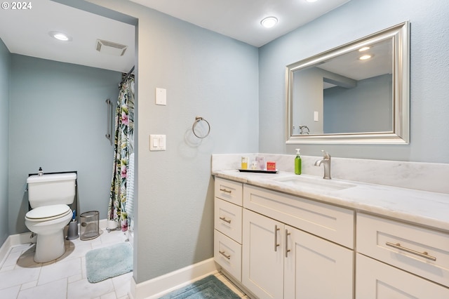 bathroom with tile patterned floors, vanity, and toilet