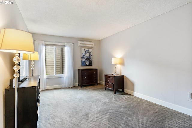 living area featuring a wall mounted air conditioner, light colored carpet, and a textured ceiling