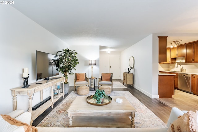 living room featuring light wood-type flooring and sink