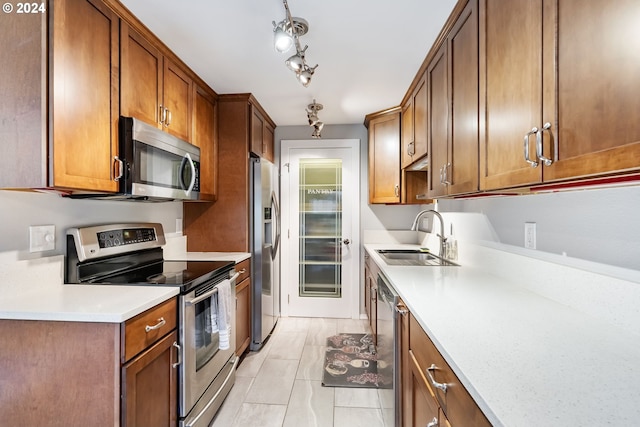 kitchen featuring sink, light tile patterned floors, and stainless steel appliances