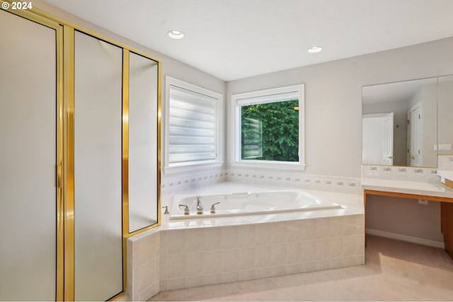 bathroom with vanity and shower with separate bathtub