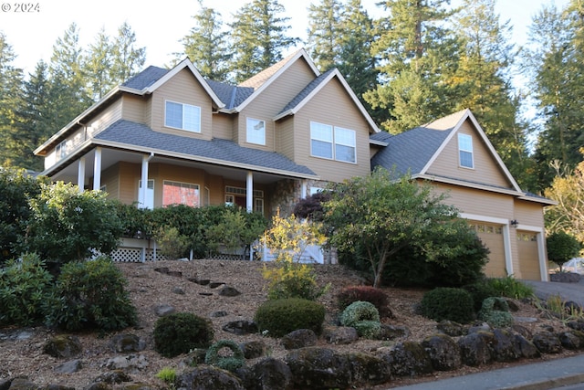 craftsman-style home with covered porch and a garage