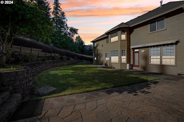 yard at dusk with a patio area