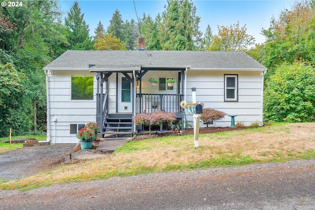 view of front of house with a porch and a front yard