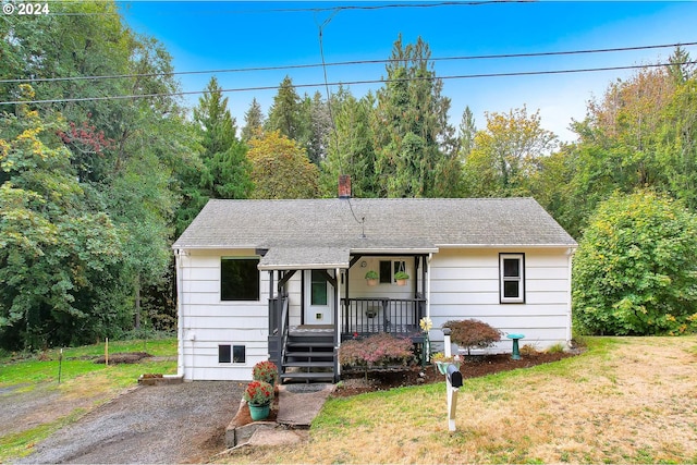33062 Bellcrest Rd, Scappoose, OR 97056 - view of front facade with a porch, a chimney, roof with shingles, and a front yard