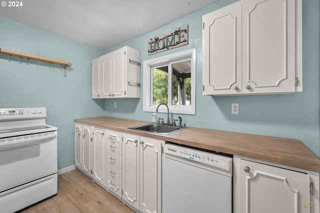 kitchen with white cabinets, white appliances, butcher block counters, and sink