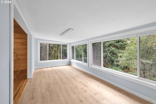 unfurnished sunroom with vaulted ceiling