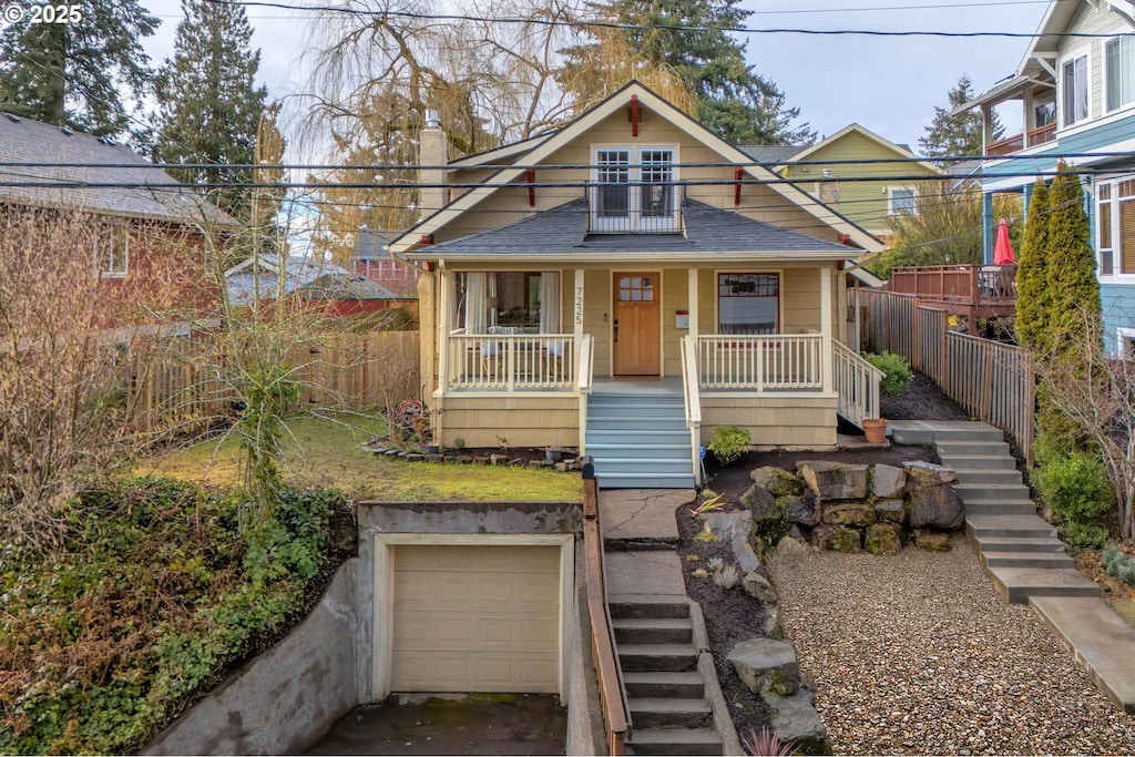 bungalow featuring a garage, covered porch, fence, and a chimney