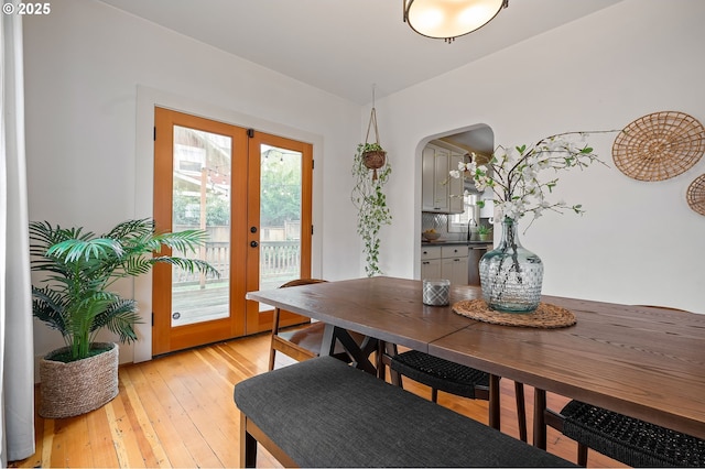 dining area featuring light wood-style floors and french doors