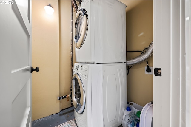 clothes washing area with laundry area and stacked washer / drying machine