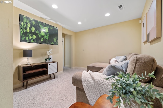 living room featuring light colored carpet, visible vents, baseboards, and recessed lighting