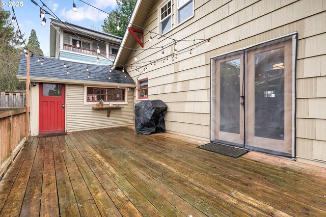 deck featuring a grill and fence