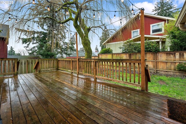 wooden terrace featuring fence