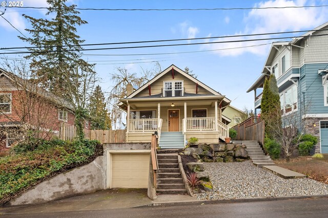 bungalow-style home with a garage, covered porch, driveway, and stairway