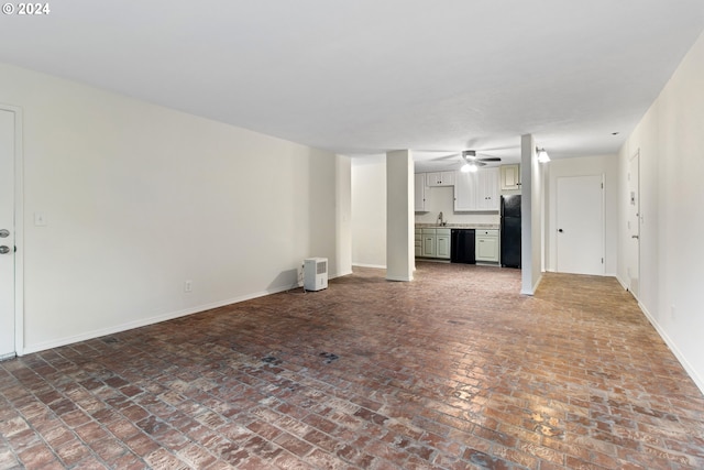 unfurnished living room with ceiling fan and sink