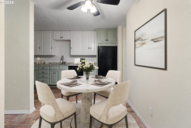 dining area with baseboards and a ceiling fan