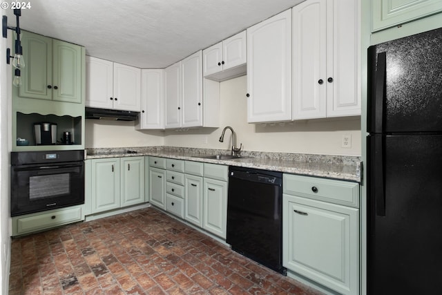 kitchen with black appliances, a sink, under cabinet range hood, brick flooring, and light countertops