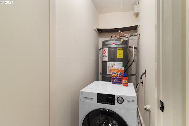 laundry area featuring strapped water heater and washer / clothes dryer