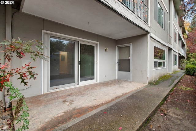 property entrance featuring stucco siding and a patio area