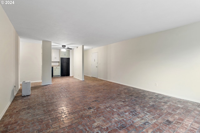 unfurnished living room with ceiling fan