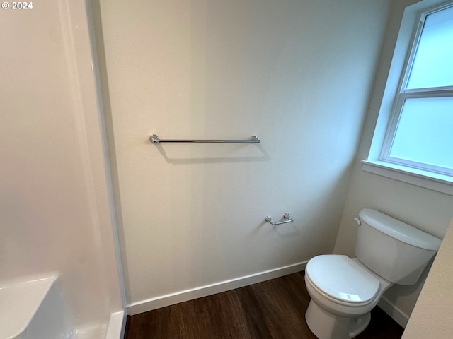 bathroom featuring toilet and wood-type flooring