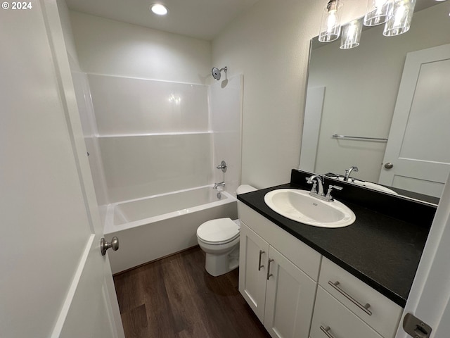 full bathroom with vanity, toilet, hardwood / wood-style floors, and shower / bathing tub combination