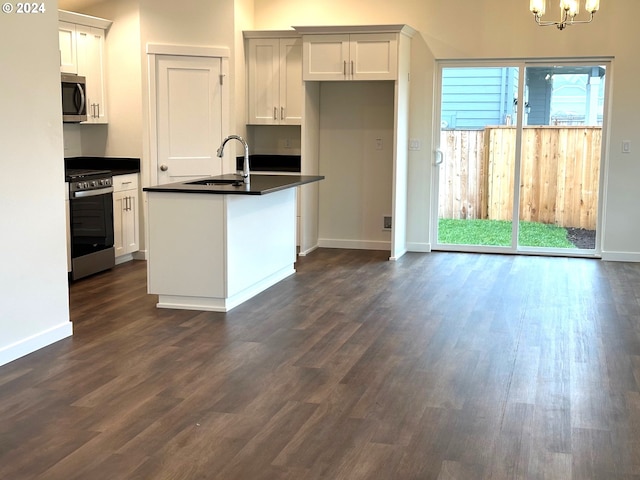 kitchen featuring dark wood-type flooring, sink, white cabinets, and appliances with stainless steel finishes